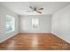 Light-filled living room boasting gleaming hardwood floors and a contemporary ceiling fan at 116 Honeywood Ave, Charlotte, NC 28216