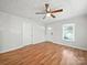 Inviting living room featuring hardwood floors, a ceiling fan, and ample natural light at 116 Honeywood Ave, Charlotte, NC 28216