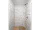 Shower stall featuring stylish marble-patterned walls, modern fixture, and updated faucet at 116 Honeywood Ave, Charlotte, NC 28216