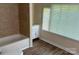 Bathroom features tub and vanity with a window at 1849 Hilltop Cir, Gastonia, NC 28054