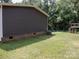 Backyard with green lawn, trees, and play equipment at 1856 Kemp Cir, Shelby, NC 28152