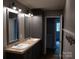 Bathroom with double vanity, wooden floors, and large mirror at 1856 Kemp Cir, Shelby, NC 28152