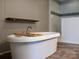 Freestanding tub with a mounted faucet and wood flooring at 1856 Kemp Cir, Shelby, NC 28152