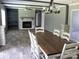 Open-concept dining room with modern lighting and a cozy fireplace at 1856 Kemp Cir, Shelby, NC 28152