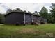 Home exterior featuring a backyard and wooden deck at 1856 Kemp Cir, Shelby, NC 28152