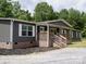 Inviting home with cozy front porch, brick foundation, and well-maintained landscaping at 1856 Kemp Cir, Shelby, NC 28152
