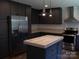 Stylish kitchen with dark cabinets, stainless steel appliances, and a functional island at 1856 Kemp Cir, Shelby, NC 28152