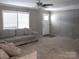 Bright living room features large windows and a comfortable gray sectional at 1856 Kemp Cir, Shelby, NC 28152