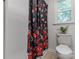 This bathroom offers a toilet, shower, and floral curtain at 1919 Gay St, Statesville, NC 28625