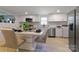 Stylish eat-in kitchen features stainless appliances and white cabinets and plenty of natural light at 1919 Gay St, Statesville, NC 28625