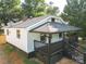 View of the home's rear exterior with porch, yard, and new roof at 1919 Gay St, Statesville, NC 28625