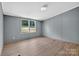 Bright, neutral bedroom with large windows and modern vinyl flooring at 2611 Dallas Stanley Hwy, Stanley, NC 28164