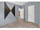 The bedroom features wood floors and an abstract accent wall at 2611 Dallas Stanley Hwy, Stanley, NC 28164