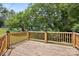 Wooden deck with wooden railing overlooking a green lawn and mature trees at 2611 Dallas Stanley Hwy, Stanley, NC 28164
