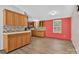 Traditional kitchen with wooden cabinets, light countertops, mosaic tile backsplash, and new vinyl flooring at 2611 Dallas Stanley Hwy, Stanley, NC 28164