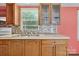 Kitchen features mosaic backsplash, wood cabinets, and stainless steel sink at 2611 Dallas Stanley Hwy, Stanley, NC 28164