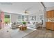 Staged living room with large L sofa, neutral paint, and a view to the backyard at 2611 Dallas Stanley Hwy, Stanley, NC 28164