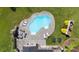 Aerial view showcasing the pool, surrounding patio, outdoor kitchen, and lush landscaping of the property at 330 Waters Rd, Salisbury, NC 28146