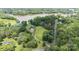 Aerial view of the home showcasing its beautiful lakeside setting, lush landscaping, and private driveway at 330 Waters Rd, Salisbury, NC 28146