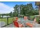 Elevated back porch featuring an outdoor seating area with lake views and a black metal safety fence at 330 Waters Rd, Salisbury, NC 28146