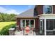 An elevated brick back porch with a seating area and beautiful lakeside views at 330 Waters Rd, Salisbury, NC 28146