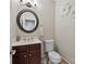 Powder room with elegant mirror, vanity, toilet, and decorative wall art at 330 Waters Rd, Salisbury, NC 28146