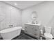 Bathroom showcasing modern tub, marble wall tiles, sleek vanity, and dark flooring at 330 Waters Rd, Salisbury, NC 28146