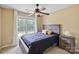 Bedroom featuring a ceiling fan, large window, and bedside table at 330 Waters Rd, Salisbury, NC 28146