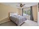 Bedroom featuring a queen sized bed, a gray comforter, carpet, and an exterior window with tree views at 330 Waters Rd, Salisbury, NC 28146