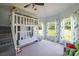Spacious bedroom featuring a custom bunk bed, two windows, carpet, and whimsical tree print curtains at 330 Waters Rd, Salisbury, NC 28146