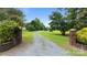 Long, winding driveway leading to a beautiful home, surrounded by lush greenery and mature trees at 330 Waters Rd, Salisbury, NC 28146