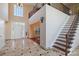 Bright foyer with high ceilings, staircase, chandelier, and natural light shining through the entry door at 330 Waters Rd, Salisbury, NC 28146