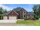 Charming brick home with a well-manicured lawn, three-car garage, and beautiful landscaping at 330 Waters Rd, Salisbury, NC 28146