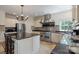 Spacious kitchen featuring stainless steel appliances, a large island, tile backsplash, and natural light at 330 Waters Rd, Salisbury, NC 28146