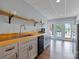 Basement kitchenette with wooden countertop, sink, cabinets, and access to the pool at 330 Waters Rd, Salisbury, NC 28146