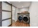 Laundry room with washer, dryer, and a sliding barn door to bathroom at 330 Waters Rd, Salisbury, NC 28146