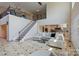 Open-concept living area with staircase, hardwood floors, fireplace, and open access to the kitchen at 330 Waters Rd, Salisbury, NC 28146