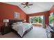 Red painted main bedroom featuring vaulted ceilings, lake views, and a comfy bed at 330 Waters Rd, Salisbury, NC 28146