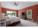 Red painted main bedroom featuring a vaulted ceiling, lake views, carpet, and a large dresser at 330 Waters Rd, Salisbury, NC 28146