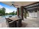 This patio boasts a large table and chairs with stone columns and a view of the pool and lawn at 330 Waters Rd, Salisbury, NC 28146