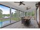 Relaxing screened porch featuring wood floors, ceiling fans, and views of the pool and lake at 330 Waters Rd, Salisbury, NC 28146