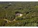 Expansive aerial view showcases a house tucked among dense trees, revealing a secluded, natural environment at 4033 Hilton Lake Rd, Kannapolis, NC 28083