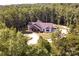 Aerial view showcasing house nestled in a lush forest, set back from a long driveway and surrounded by trees at 4033 Hilton Lake Rd, Kannapolis, NC 28083