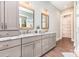 Bathroom with dual sink vanity, granite countertop, grey cabinets, wood look tile floor and view of shower and toilet at 4033 Hilton Lake Rd, Kannapolis, NC 28083