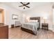 Well-lit bedroom features a ceiling fan and wood-style floors at 4033 Hilton Lake Rd, Kannapolis, NC 28083