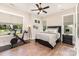 Bedroom with black furniture, wood look flooring, and large windows at 4033 Hilton Lake Rd, Kannapolis, NC 28083