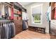 Custom closet with shelving, drawers, hanging racks, window and bench with shoe storage on the floor at 4033 Hilton Lake Rd, Kannapolis, NC 28083