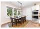 Cozy dining room with modern lighting, large windows, and a view of the backyard at 4033 Hilton Lake Rd, Kannapolis, NC 28083