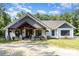 Inviting exterior with a striking timber framed entryway, stone accents, and a well manicured yard at 4033 Hilton Lake Rd, Kannapolis, NC 28083