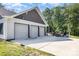 Exterior view of a detached garage with three doors and landscaping at 4033 Hilton Lake Rd, Kannapolis, NC 28083